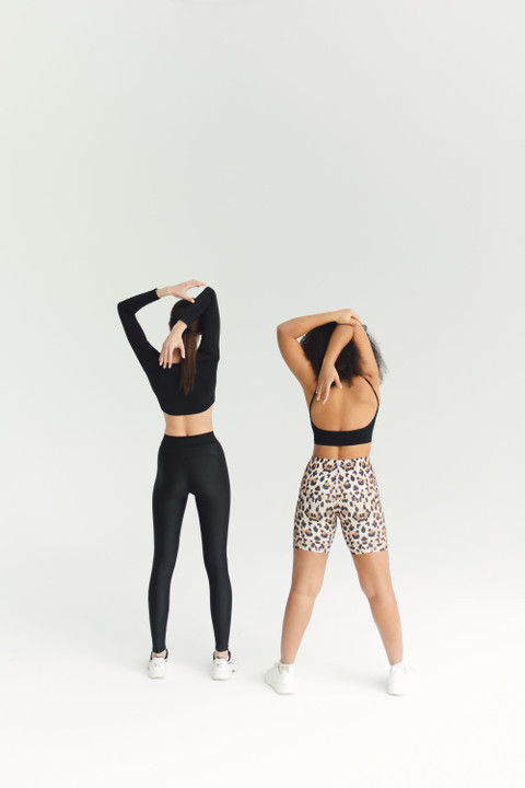 A black long-sleeve crop top and leggings, from the back.