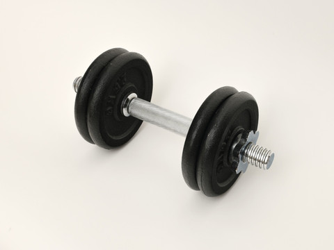 An adjustable plate dumbbell on white.