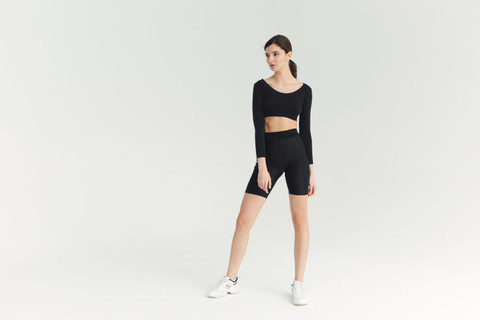 Black bike shorts with a long-sleeve crop top.