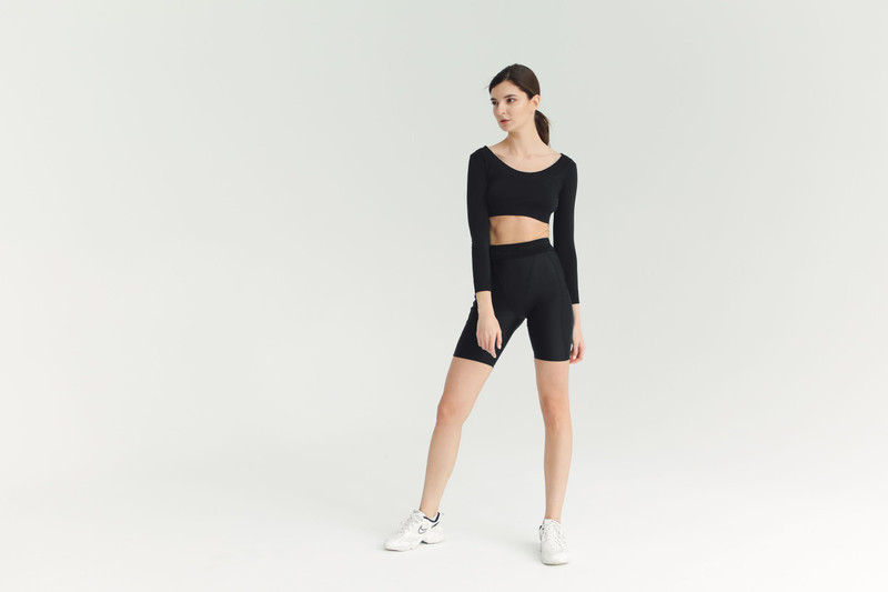 Black bike shorts with a long-sleeve crop top.
