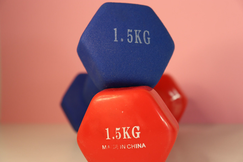 Blue and red vinyl dumbbells stacked.