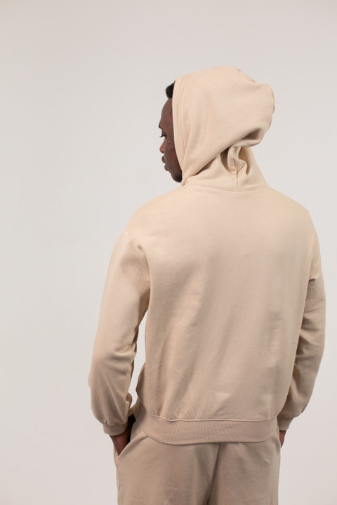 A sand fleece hoodie and joggers, from the back.