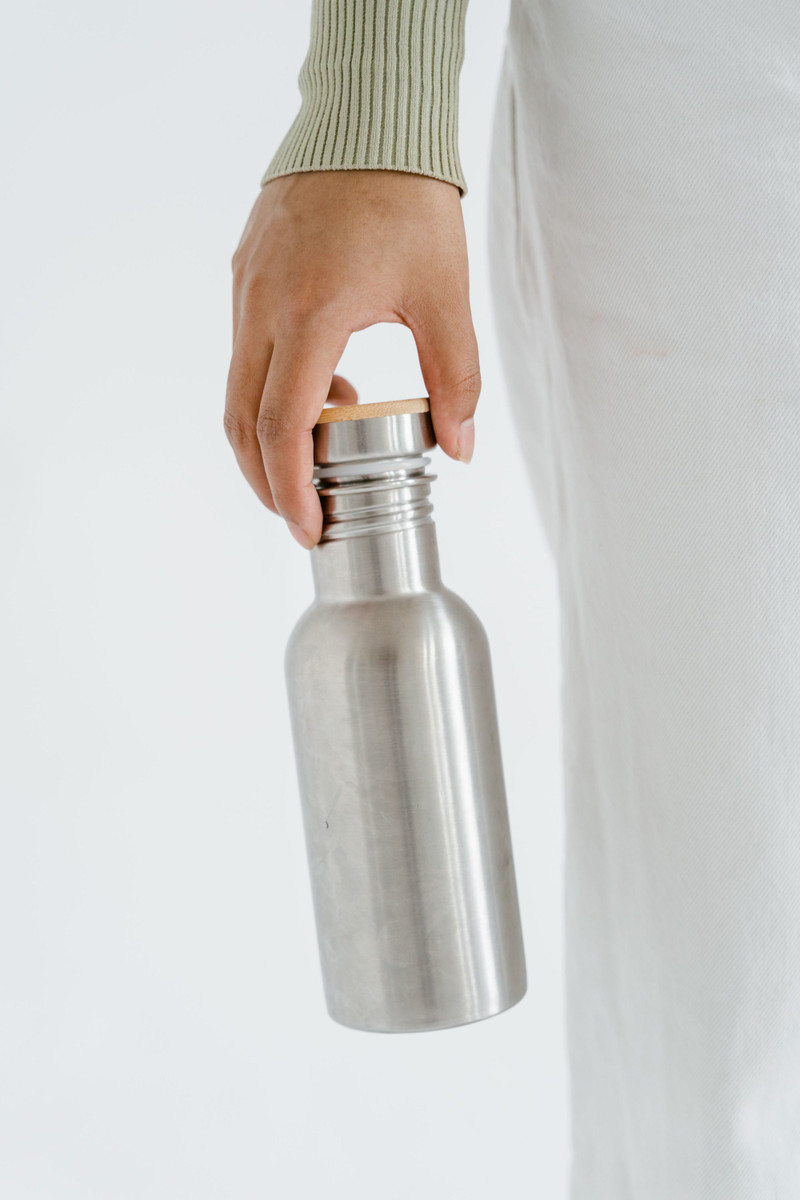 A brushed steel bottle with a bamboo cap.