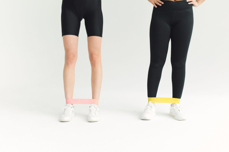 Pink and yellow mini loop bands around the knees.