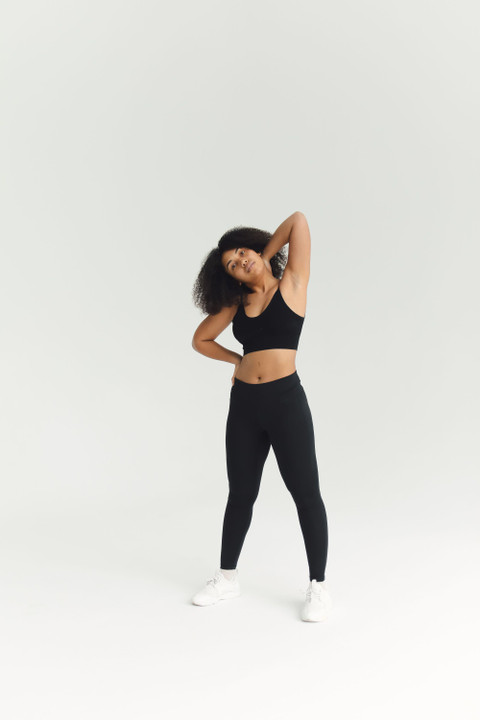 A black scoop sports bra and leggings in a stretch.
