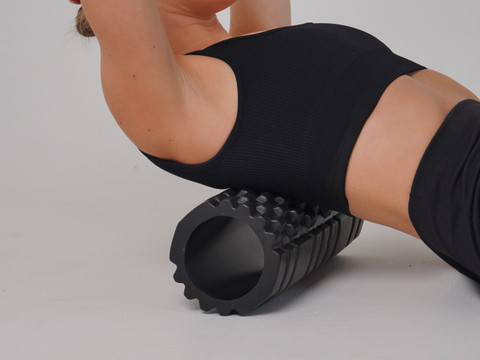 A textured foam roller under the back.