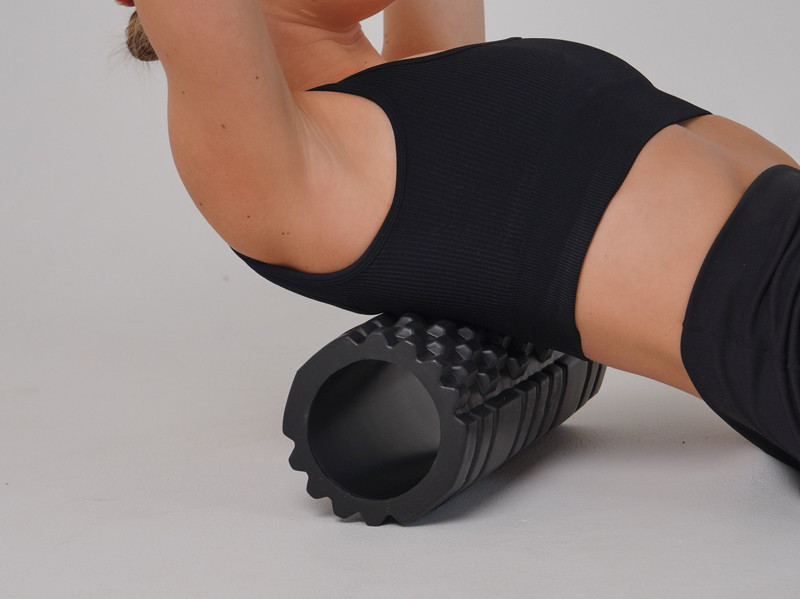A textured foam roller under the back.