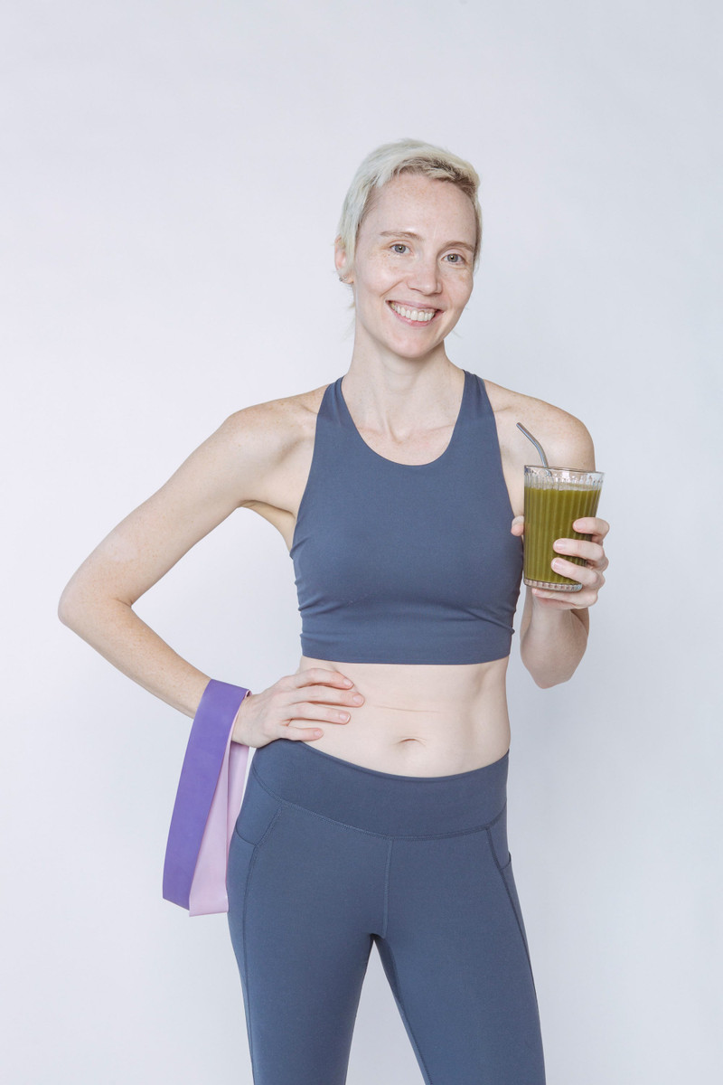 A slate-blue sports bra and leggings with a band on the wrist.
