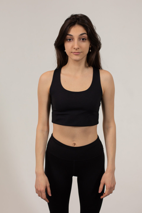 A black racerback crop top and leggings.